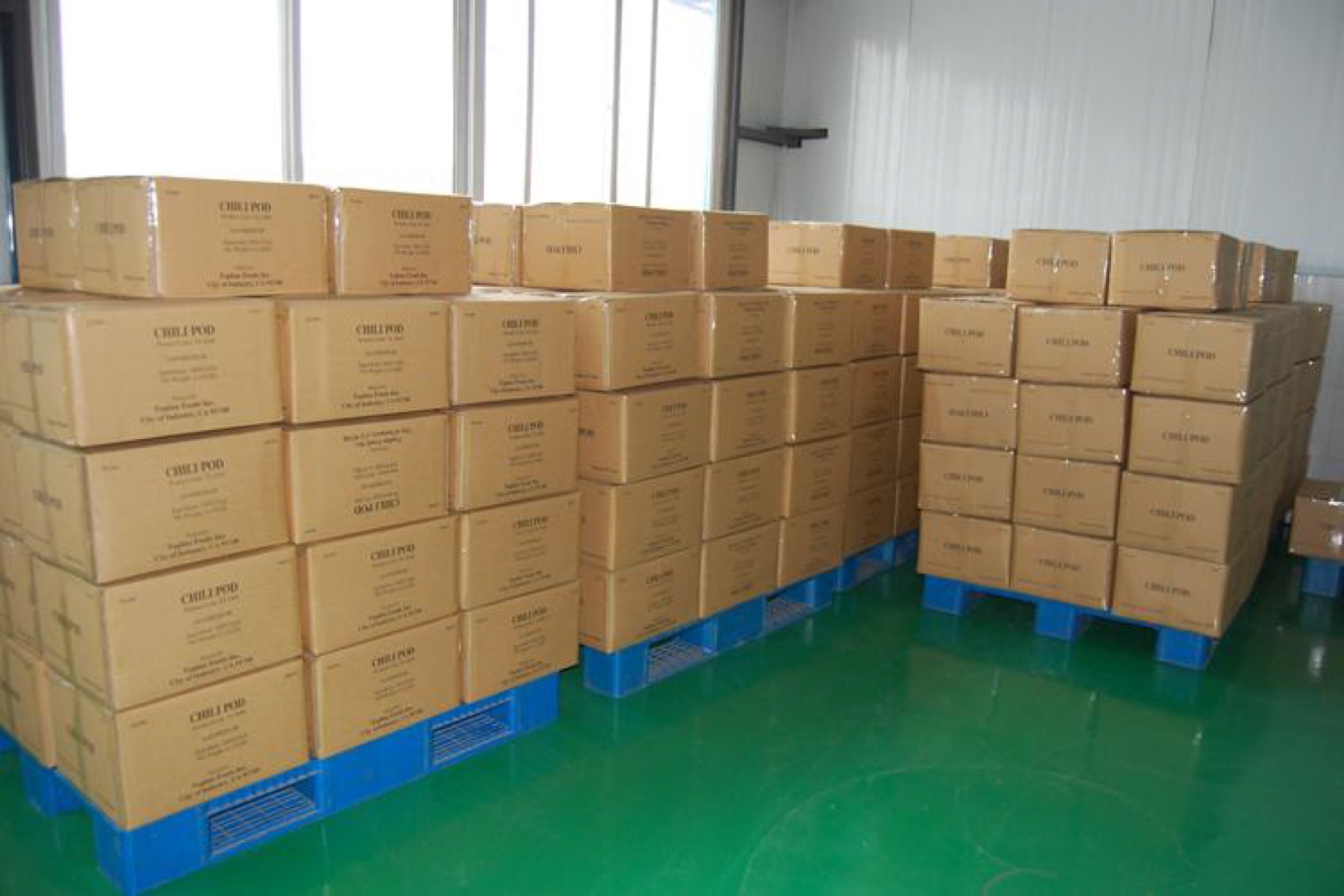 Packed cartons stored on blue pallets